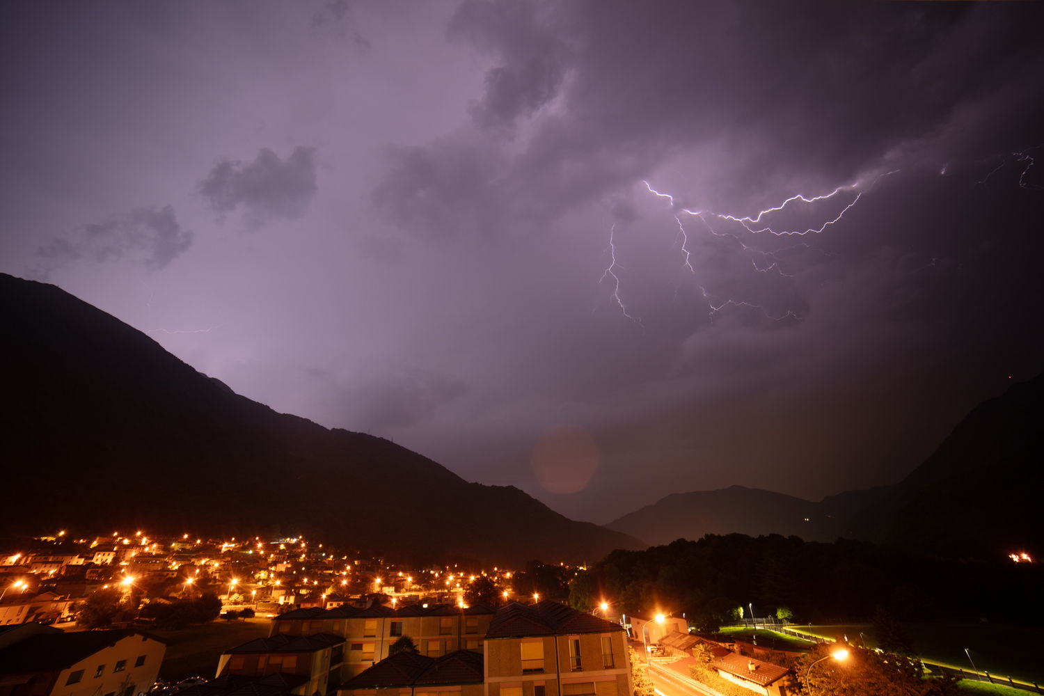 Storm over a valley town, before